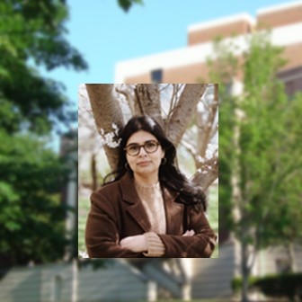 Photo of Amna Qayyum against a backdrop of the exterior of LeConte Hall, on UGA's North campus