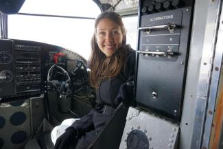 photo of Dr. Holly Miowak Guise, in a small airplane, Alaska
