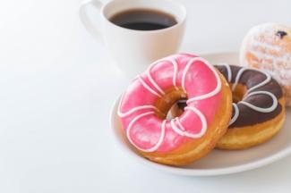 photo of a cup of coffee and donuts