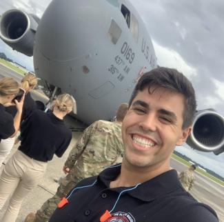 Christian Poe in front of a U.S. Bomber