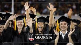 photo of UGA graduates in cap and gown, cheering at graduation