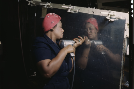 LOC: Operating a hand drill at Vultee-Nashville, woman is working on a "Vengeance" dive bomber, Tennessee