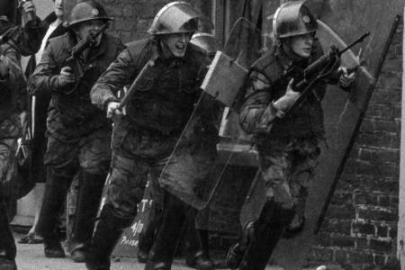 photo of men in military uniform with guns