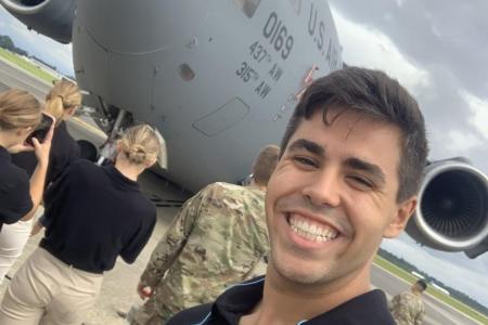 Christian Poe in front of a U.S. Bomber