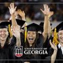 photo of UGA graduates in cap and gown, cheering at graduation